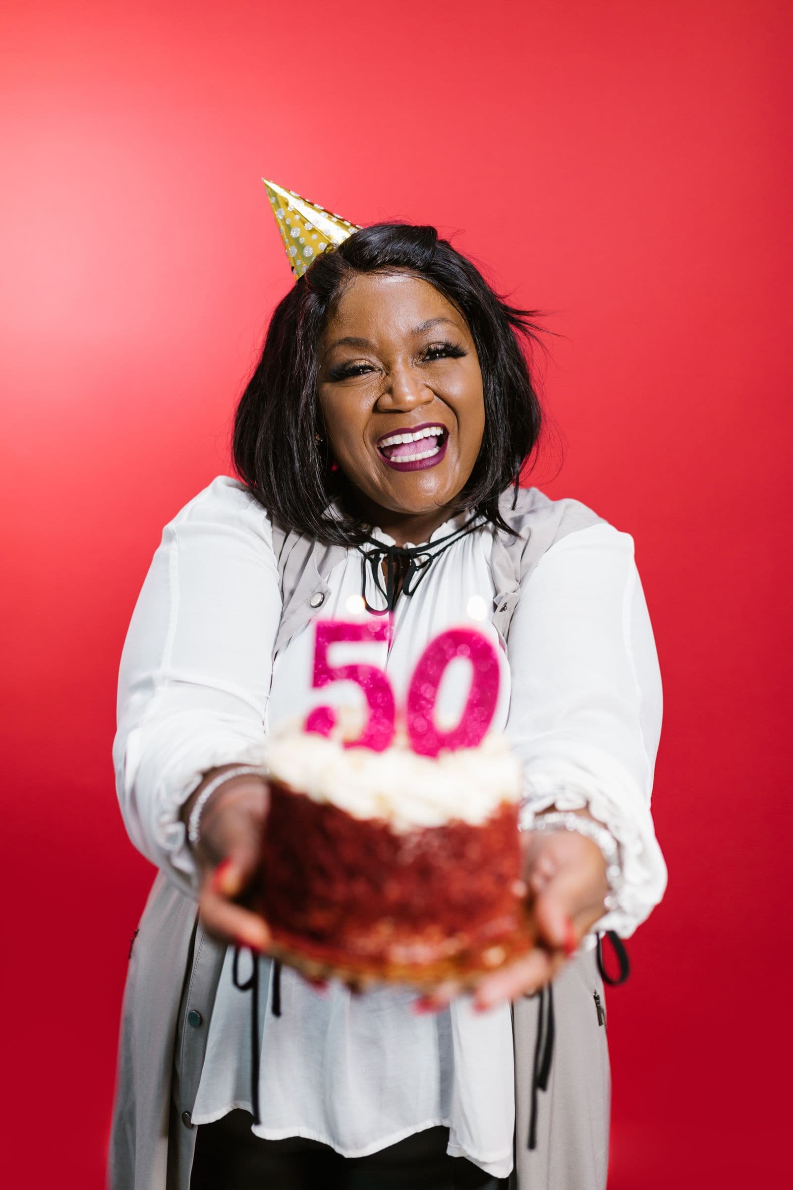 Woman holding her 50th birthday cake